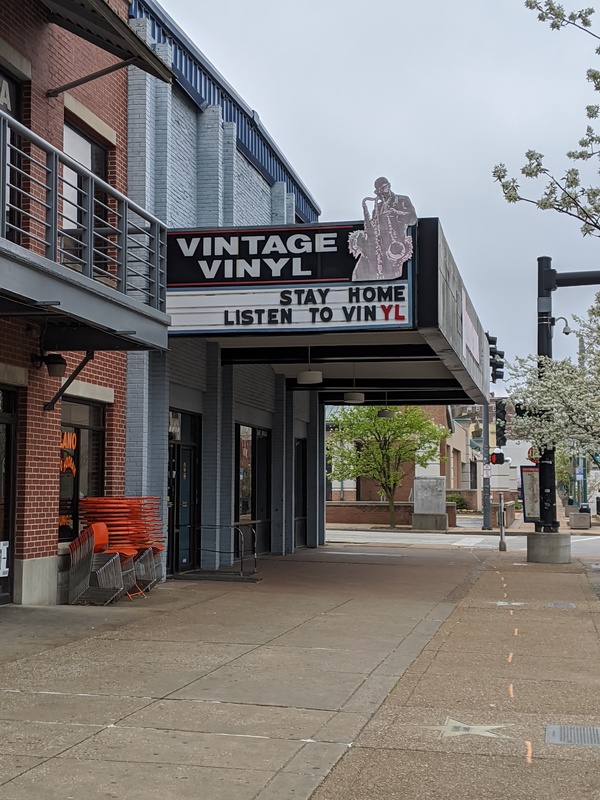 A store with a sign over the top that says: "Vintage Vinyl" and below it says "Stay home listen to vinyl". 