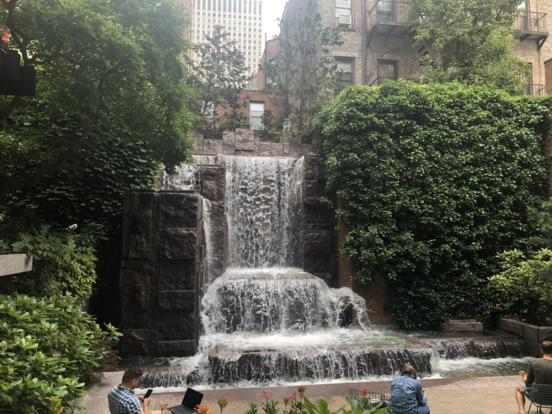 This is a picture of a man made waterfall at a public park. 