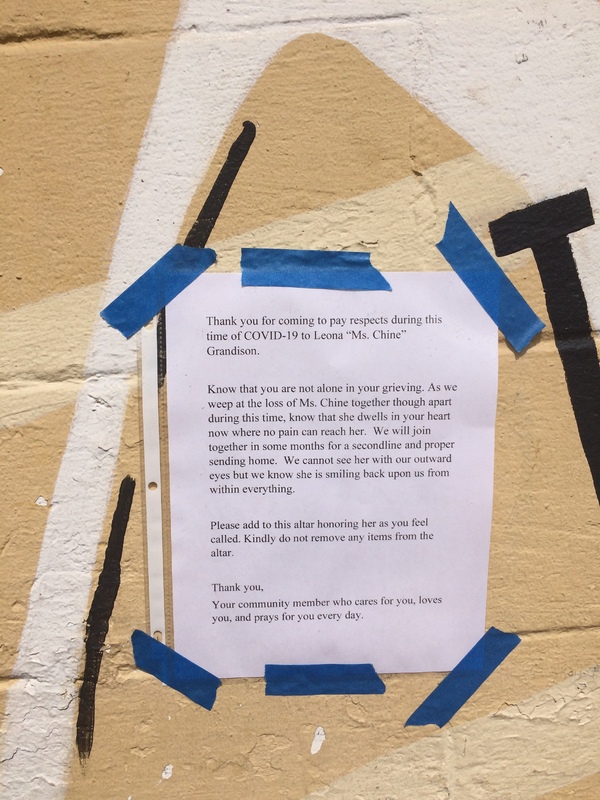 A notice within a community that is letting others know that a resident lost a loved one, and to not remove things from the altar that was created. 