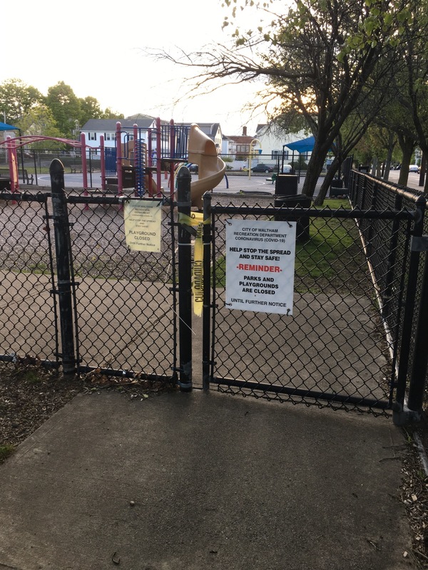 Playground with a sign on the gate saying it is closed