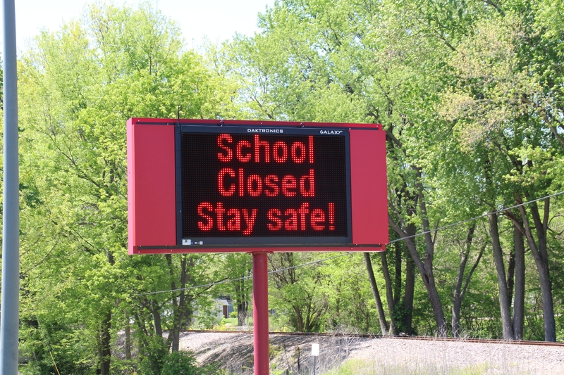 A digital sign reading "School Closed. Stay Safe!".
