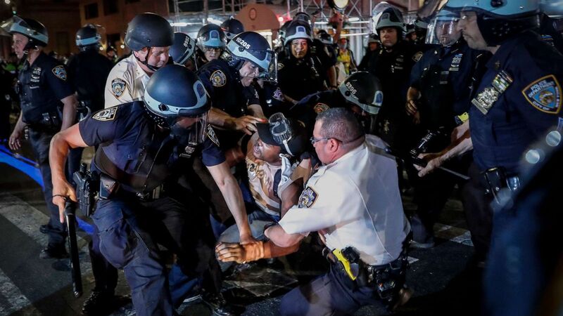 This is a picture of a group of police officers detaining a protester during the Black Lives Matter protests. 