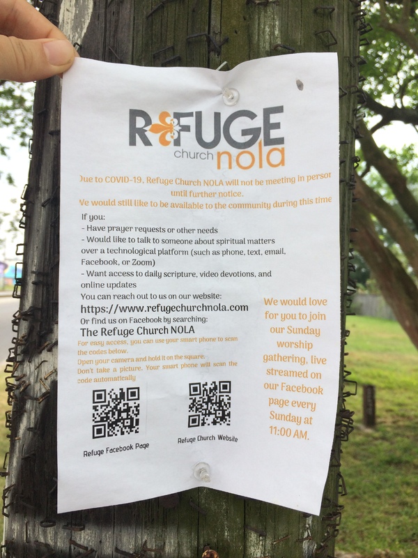 A sign by Refuge Church NOLA informing people that there will be no in person meetings, but that the church will be available via Facebook and their website. 