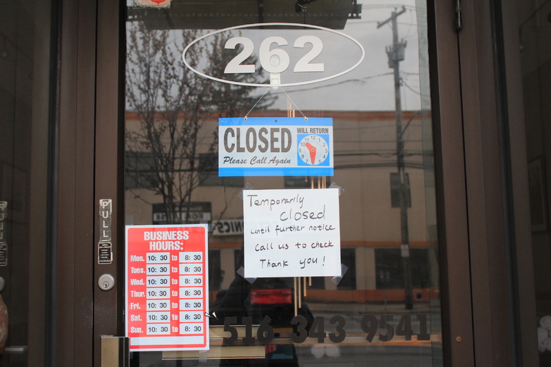 Business with hours of operation on it along with closed sign and a hand written note that says: "Temporarily closed until further notice, call us to check, thank you!"