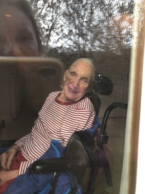 An old person smiling.