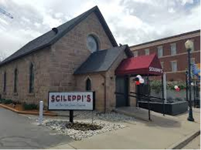 A picture taken of the outside of a stone church converted into a pizza restaurant in Colorado. 