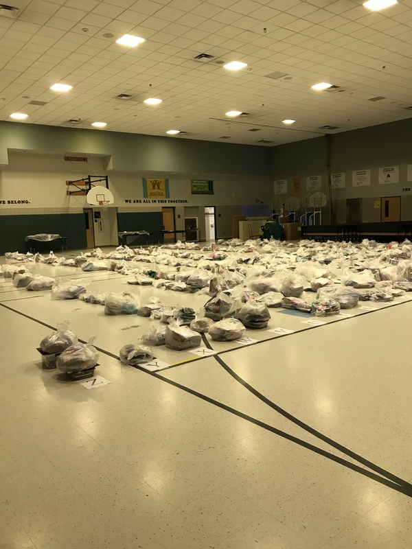 A room in an elementary school full of bags.