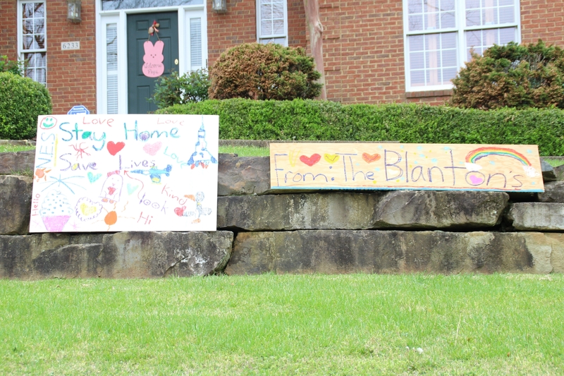 Two homemade signs in a front yard. 