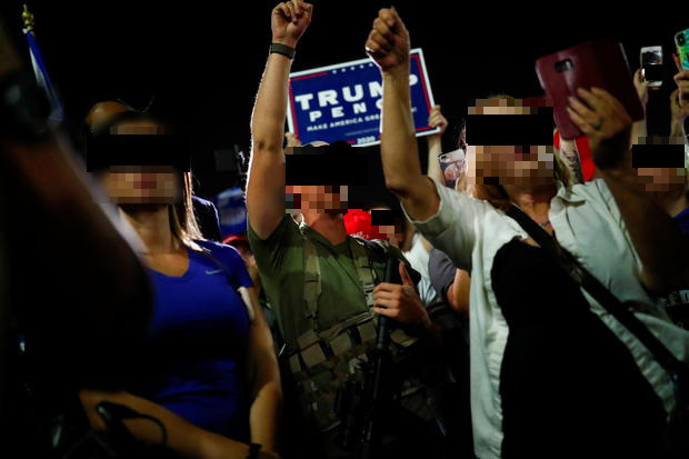 Image of a crowd protesting the 2020 Presidential election results in Phoenix, Arizona. All people in the picture have their faces blurred. 