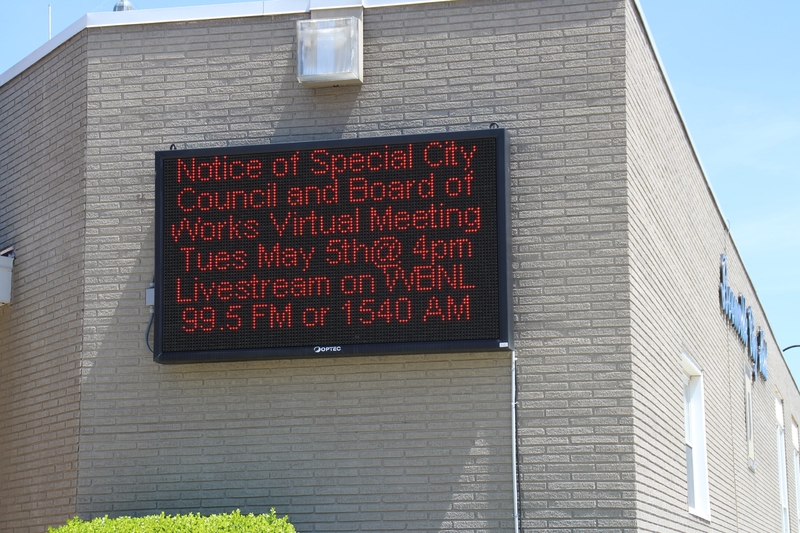Digital Sign reading "Notice of special City council and board of works virtual meeting Tues May 5th at 4 pm. Livestream on WBNL 99.5 FM or 1540 AM".