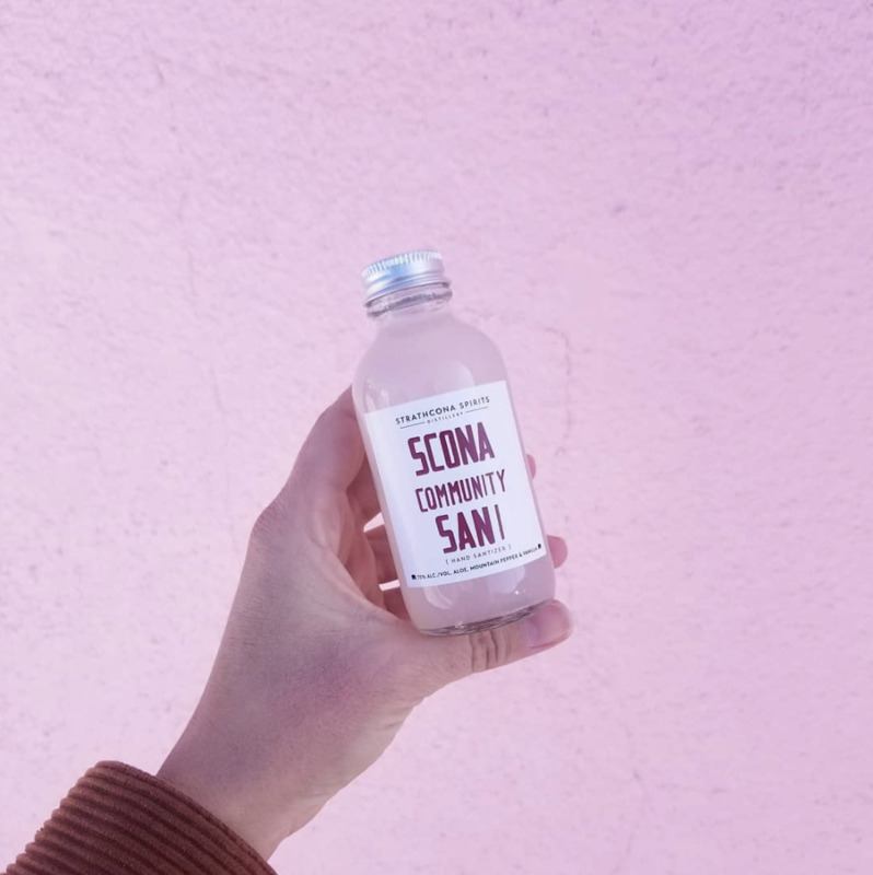 This is a picture taken of a small bottle which is labeled: "Strathcona Spirits Scona Community Sani [Hand sanitizer]."