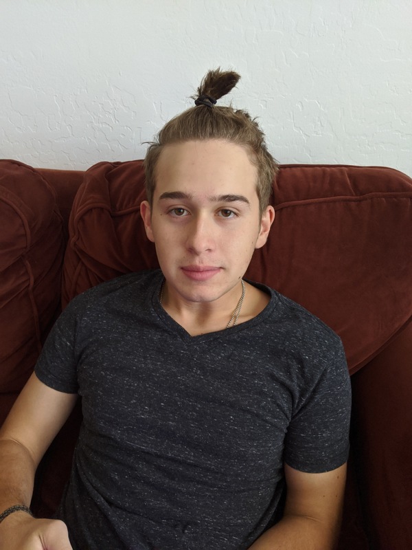A picture of a person with their hair in a bun. 
