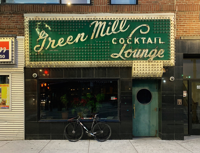 A building that says "Green Mill Cocktail Lounge". 