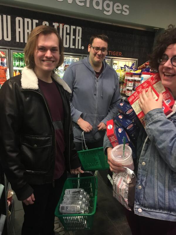 Three men in a grocery store.