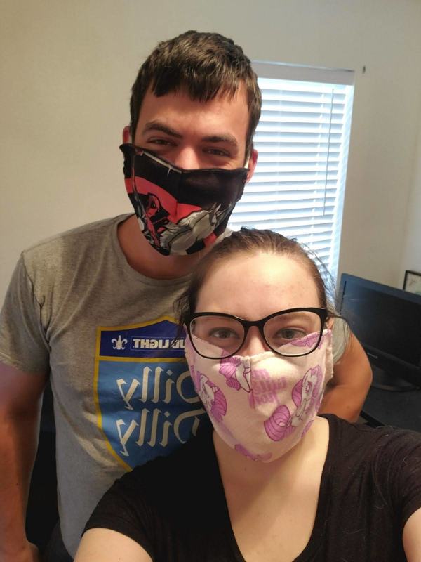 A couple wearing homemade masks. 