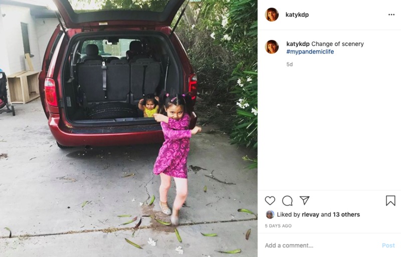 A Facebook screenshot of a photo of two little girls playing in and around a red van. 