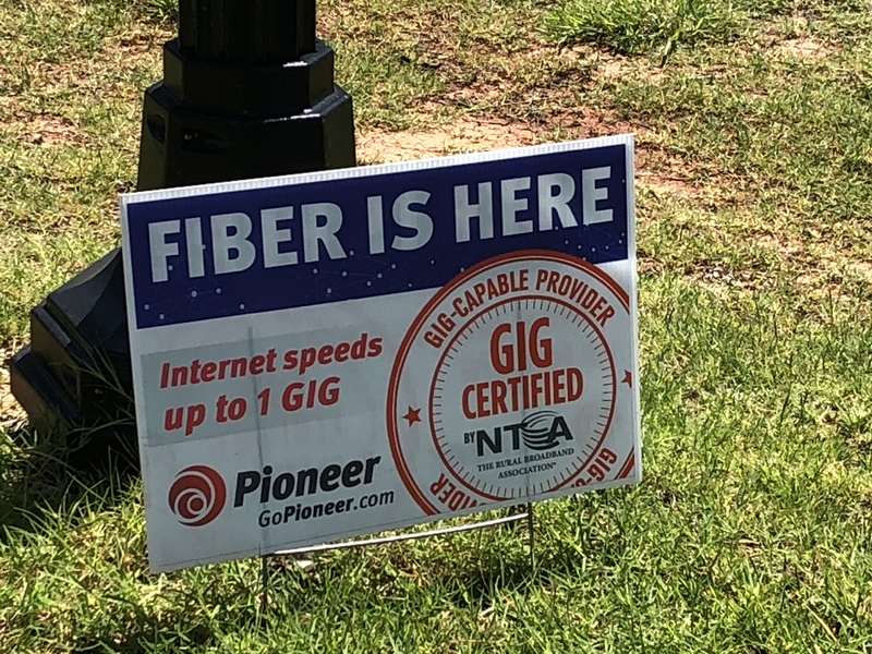 A photo of a lawn sign advertising upgraded internet speeds.