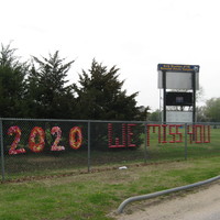 red words on a fence stating "2020 we miss you"
