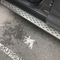 A disposable glove is on the ground in a parking lot. 