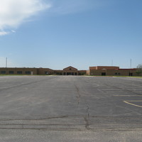 Image of an empty school parking lot.
