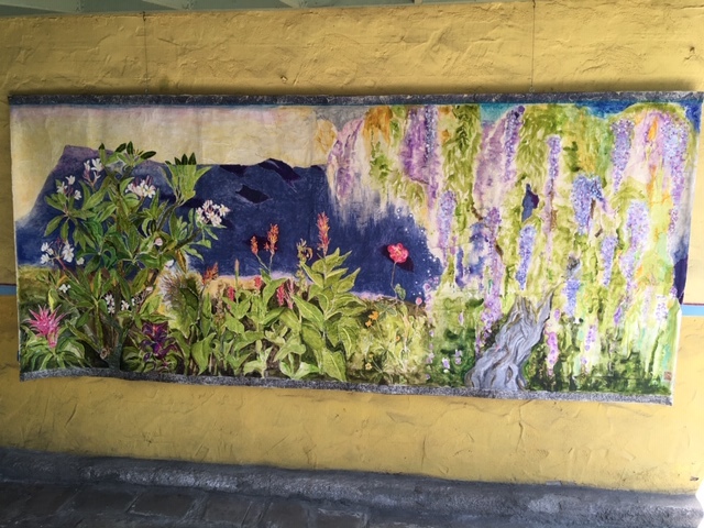 This is a picture of a mural painted which depicts various kinds of flowering plants.