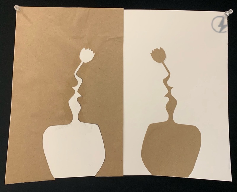 A brown and white piece of paper art.