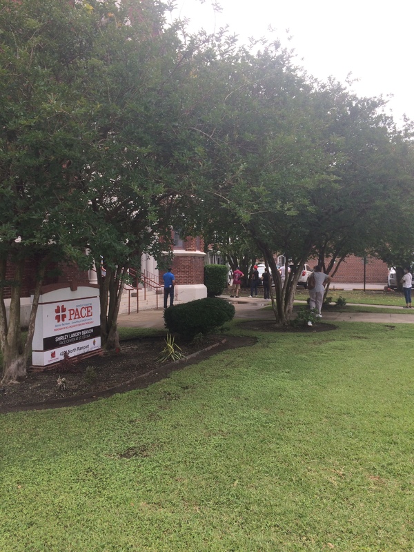 people in line at a brick building