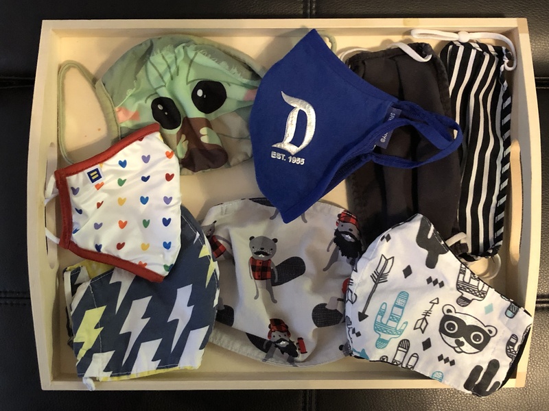 This is a picture of a collection of face masks resting inside a drawer.