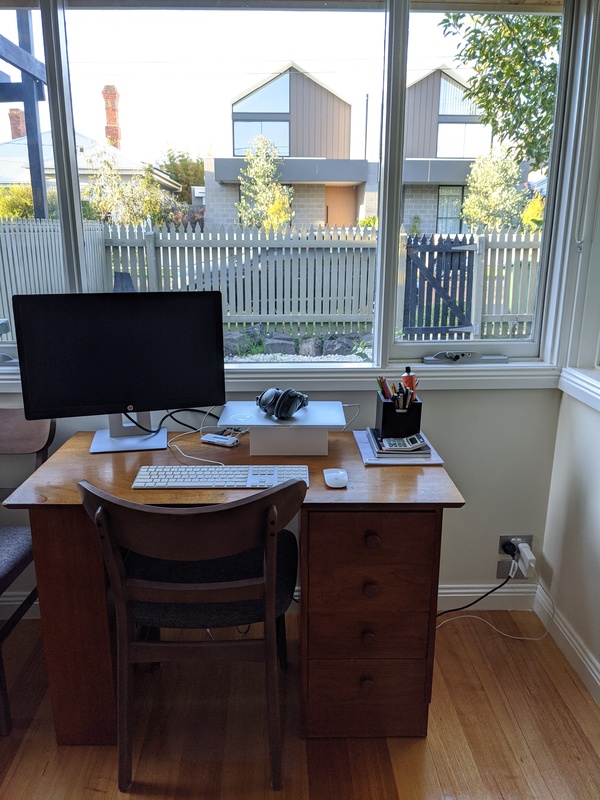A desk with a computer in a home.