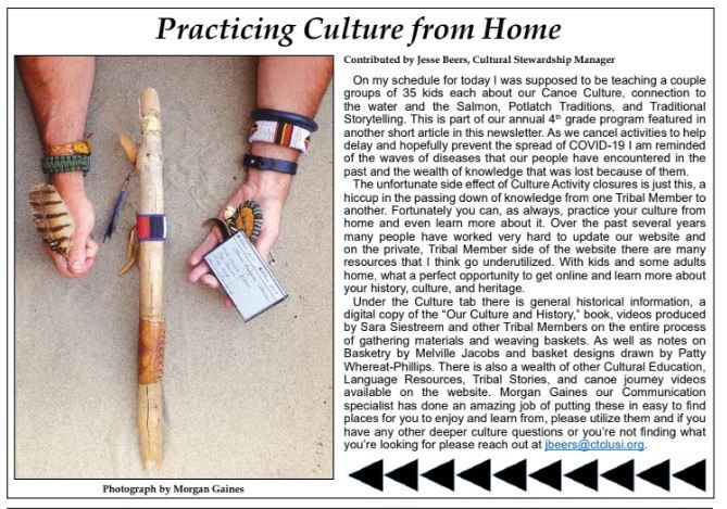 A person holding a feather and a card.