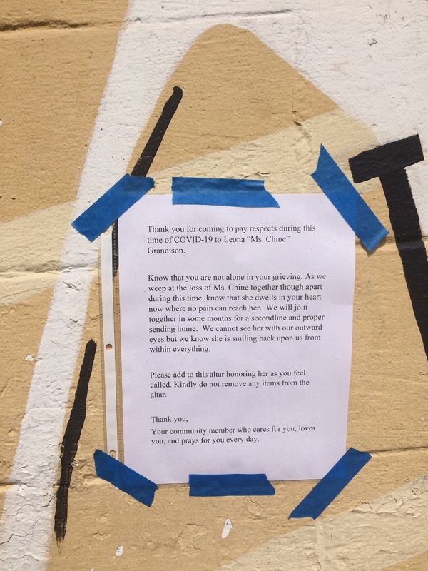 A notice within a community that is letting others know that a resident lost a loved one, and to not remove things from the altar that was created.