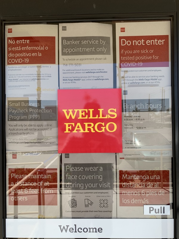 A wall of announcements behind a door.