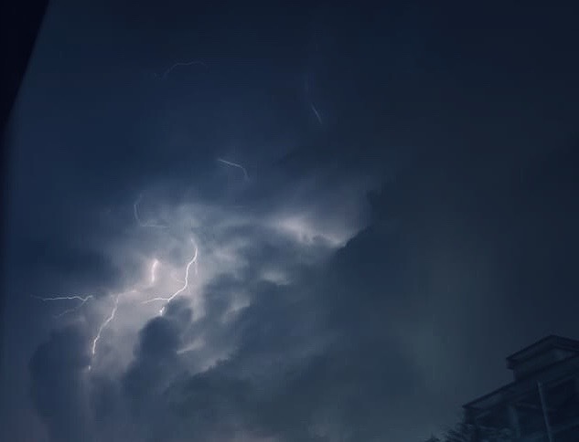 A thunderstorm in a cloudy sky.
