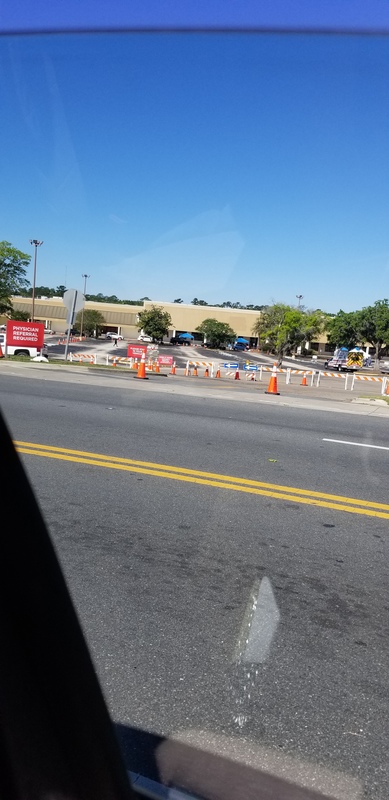 A parking lot with orange cones and road blocks.
