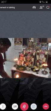 A person in front of an ofrenda.