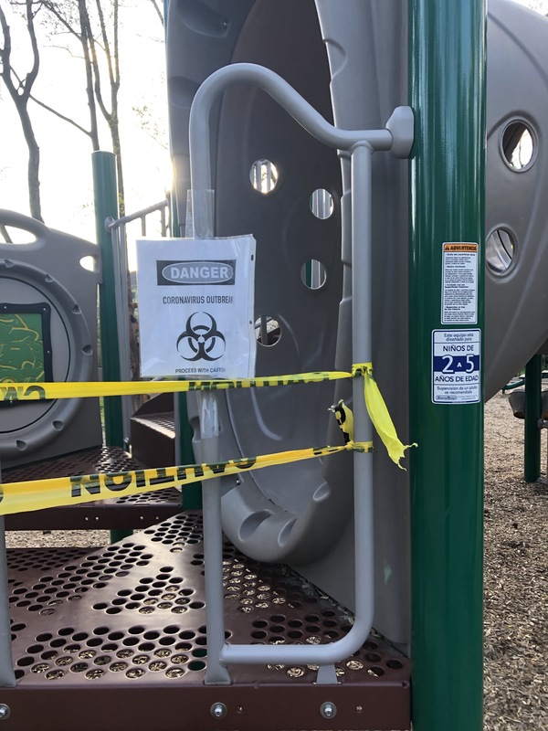 Warning tape around a playground.