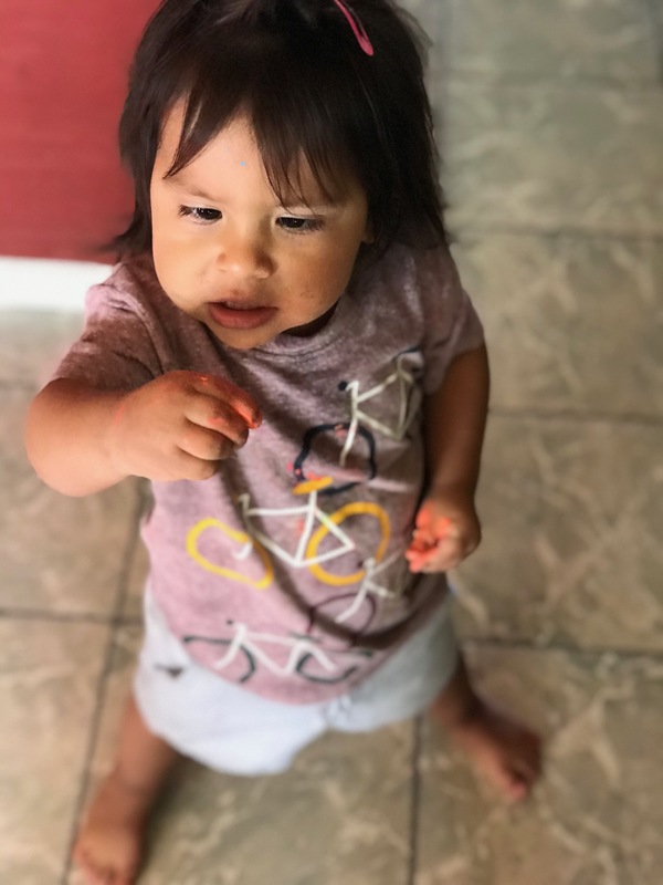 A child with paint on their fingers.