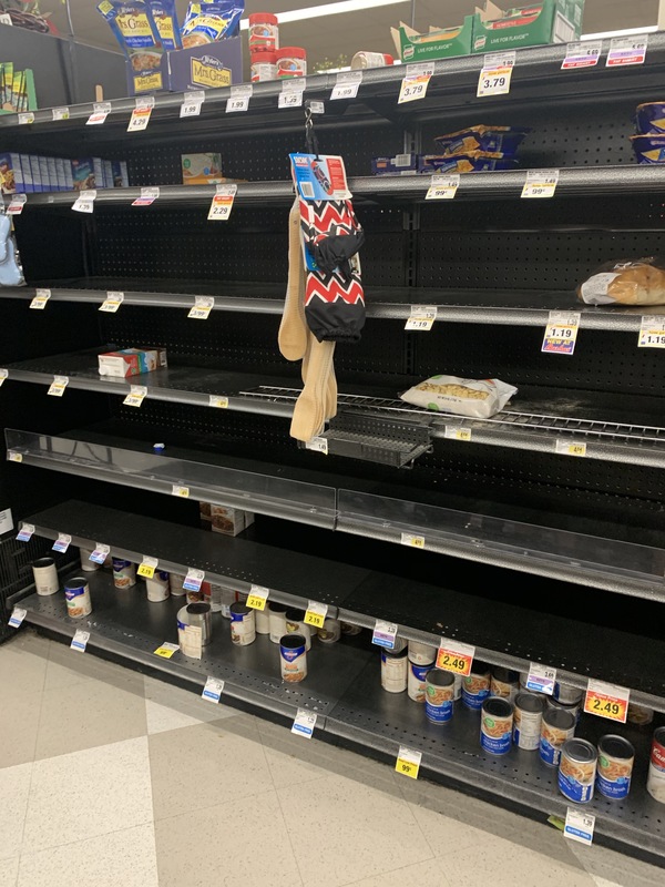 Depleted shelves in a grocery store.