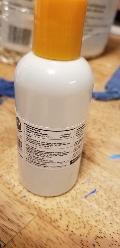 A orange and white hand sanitizer bottle.