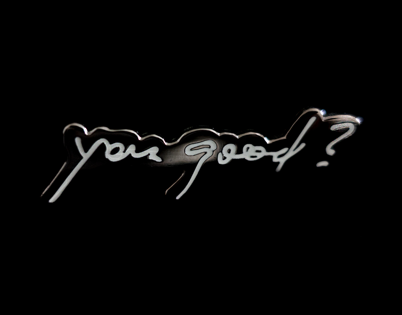 This is a picture of a graphic which depicts the words "You good?" in cursive against a black background.
