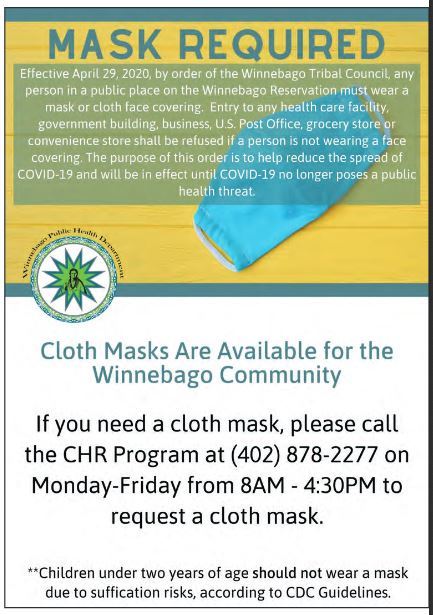 A photo of a poster informing people that any person in a public space on the Winnebago reservation is mandated to wear a mask.
