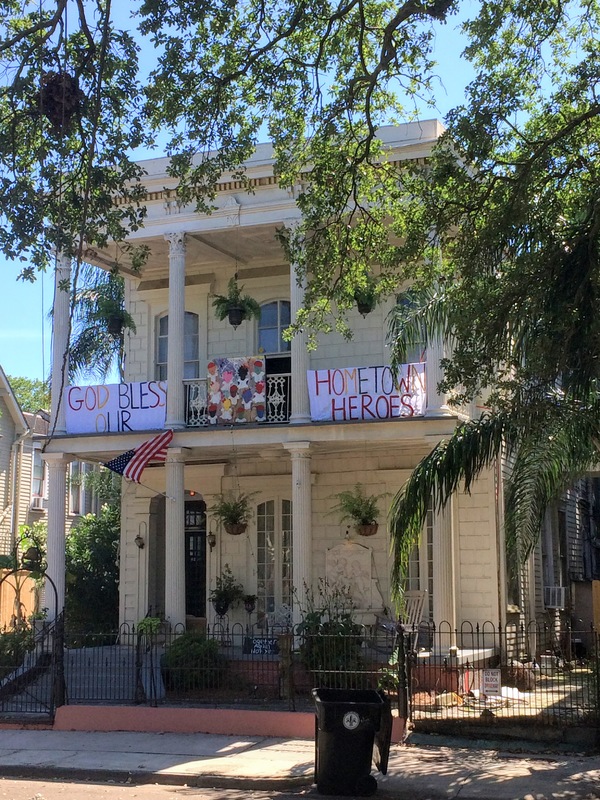 Home with sign that reads "God Bless our hometown heroes".