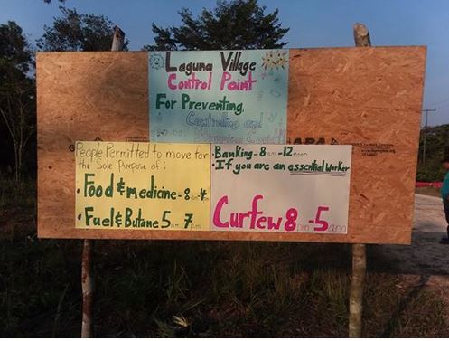 A wooden sign with flyers attached.