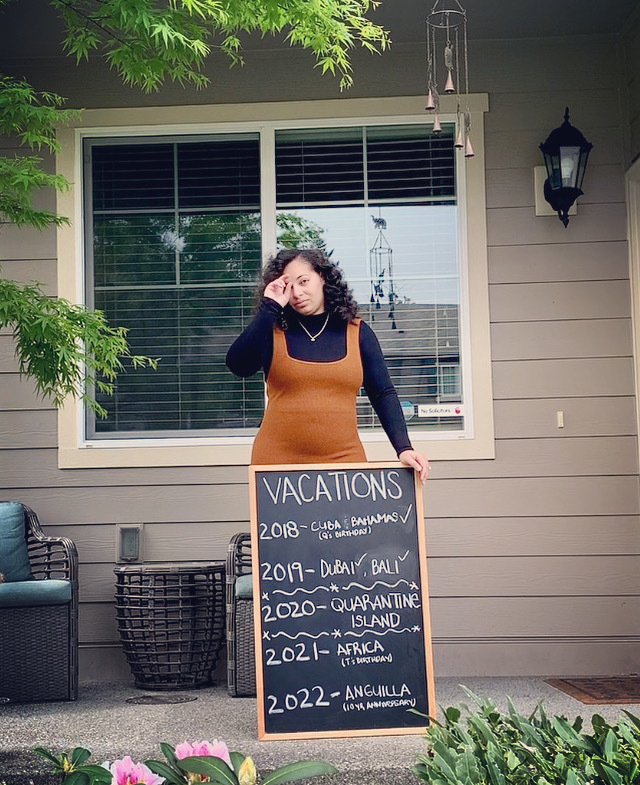 A person holding a sign outside a building. 