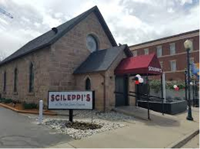 A picture taken of the outside of a stone church converted into a pizza restaurant in Colorado.