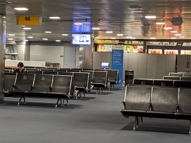 A person is sitting alone in a airport terminal.