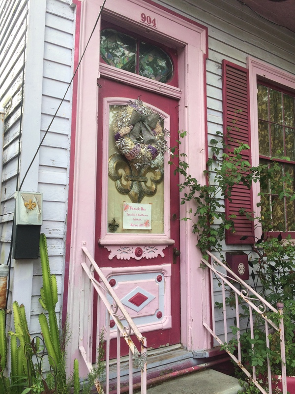 A pink door with a poster on it.