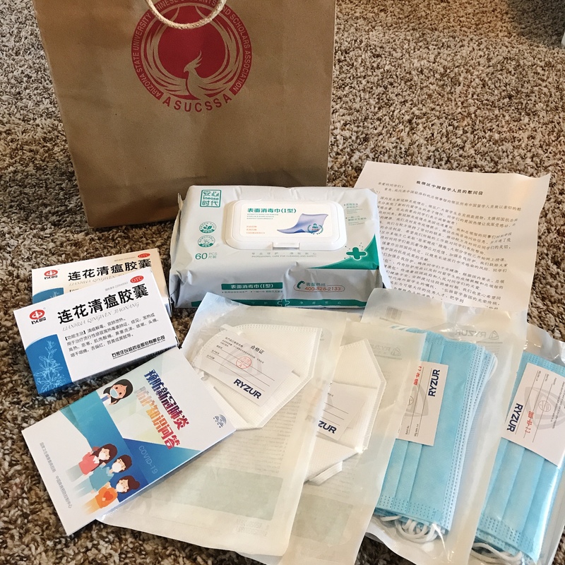 Masks and wipes laid out on the floor.