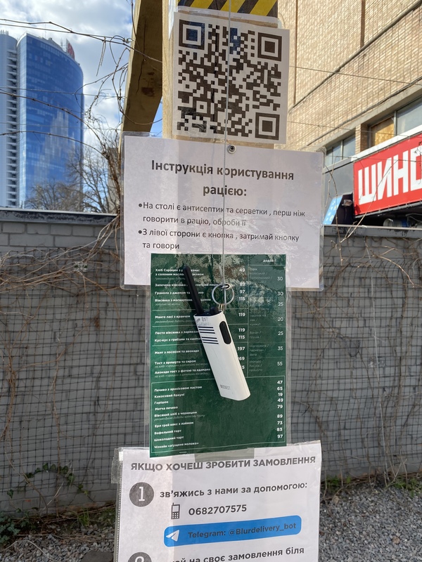 A walkie-talkie hanging from a wooden beam.