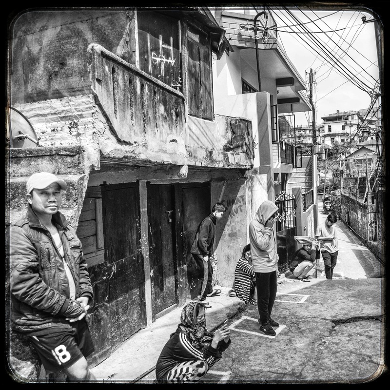 A queue of people waiting outside to get into a store.